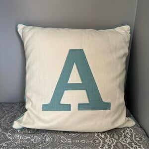 A Monogrammed Cream and Blue Throw Pillow